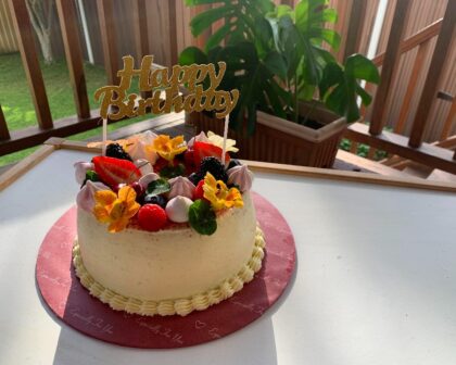 Chiffon Cake topped with fresh seasonal fruits, delicate meringues, and edible flowers